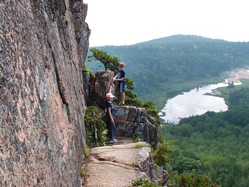 hikers on a scary section of The Beehive Trail at Acadia National Park in Maine