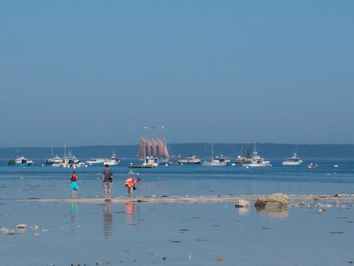 tourists at low tide out on the famous sandbar at Bar Harbor in Maine