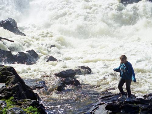 Sandra stands out on the edge at the base of Allagash Falls on the Allagash Wilderness Waterway in northern Maine