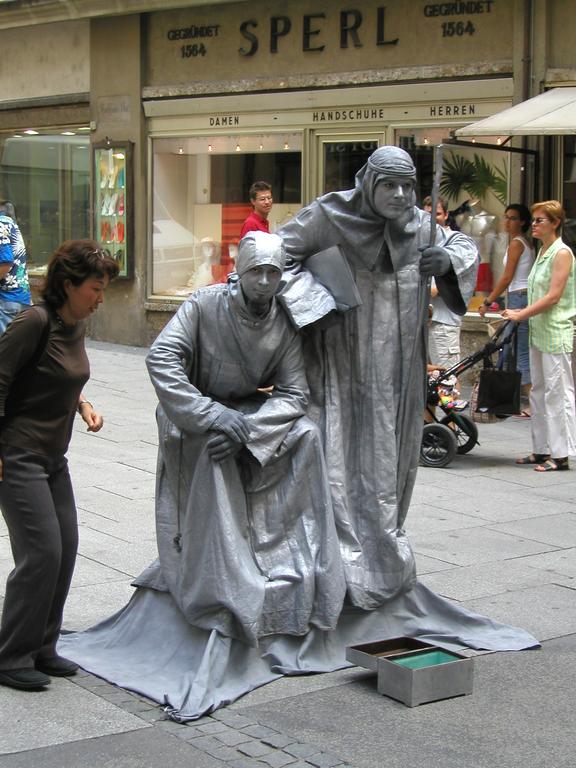 mimes doing a statue act on the sidewalk in Saltzburg, Austria