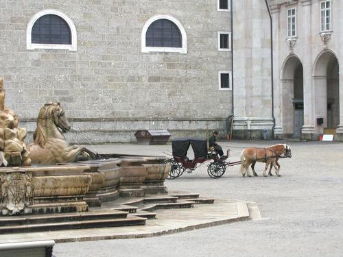 an early-morning lonely carriage passes through Salzburg's Old Center in Austria