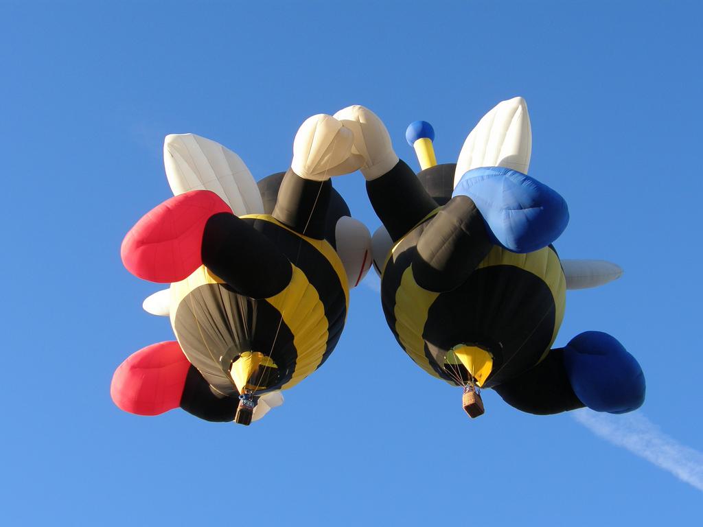 a pair of special-shape balloons (The Little Bees) kisses in the air at the Albuquergue Balloon Festival in New Mexico