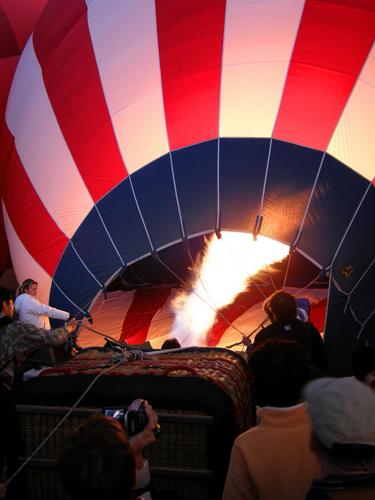 a hot-air balloon gets a blast of heat while still lying on the ground in preparation for launch in New Mexico