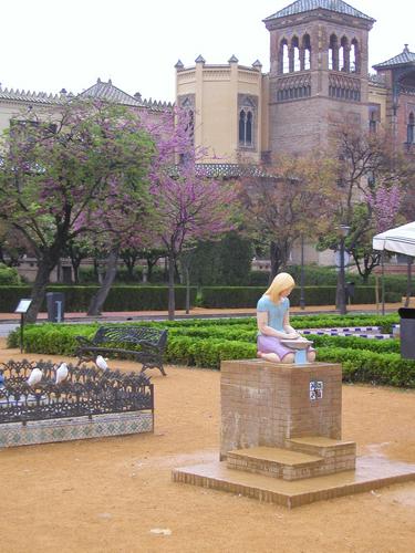 light rain softens early spring colors in this quiet plaza in Seville, Spain