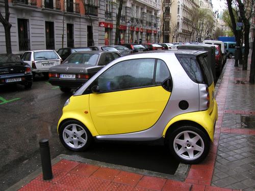Smartcar parked sideways at streetside in Madrid, Spain