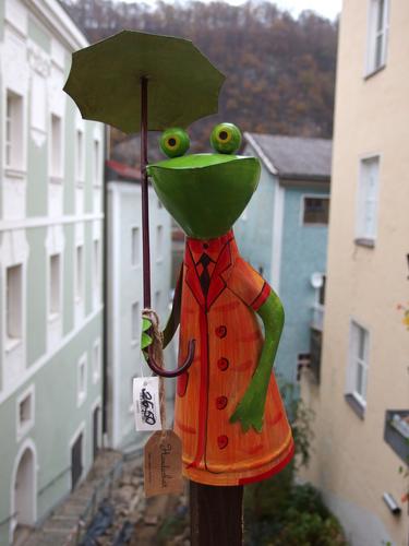 an artistic-frog gift item stands out alongside a Passau street in southeastern Germany