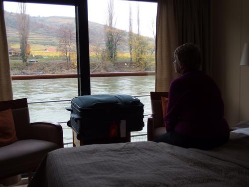 Betty Lou watches the passing view of Wachau Valley of Austria on the Danube River from our stateroom on the Viking Legend cruise ship