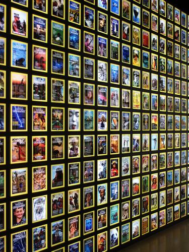 backlit wall of past magazine covers at the National Geographic Museum in Washington DC