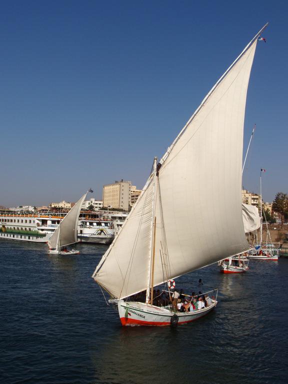 a felucca takes tourists for a cruise on the Nile River near Aswan in Egypt