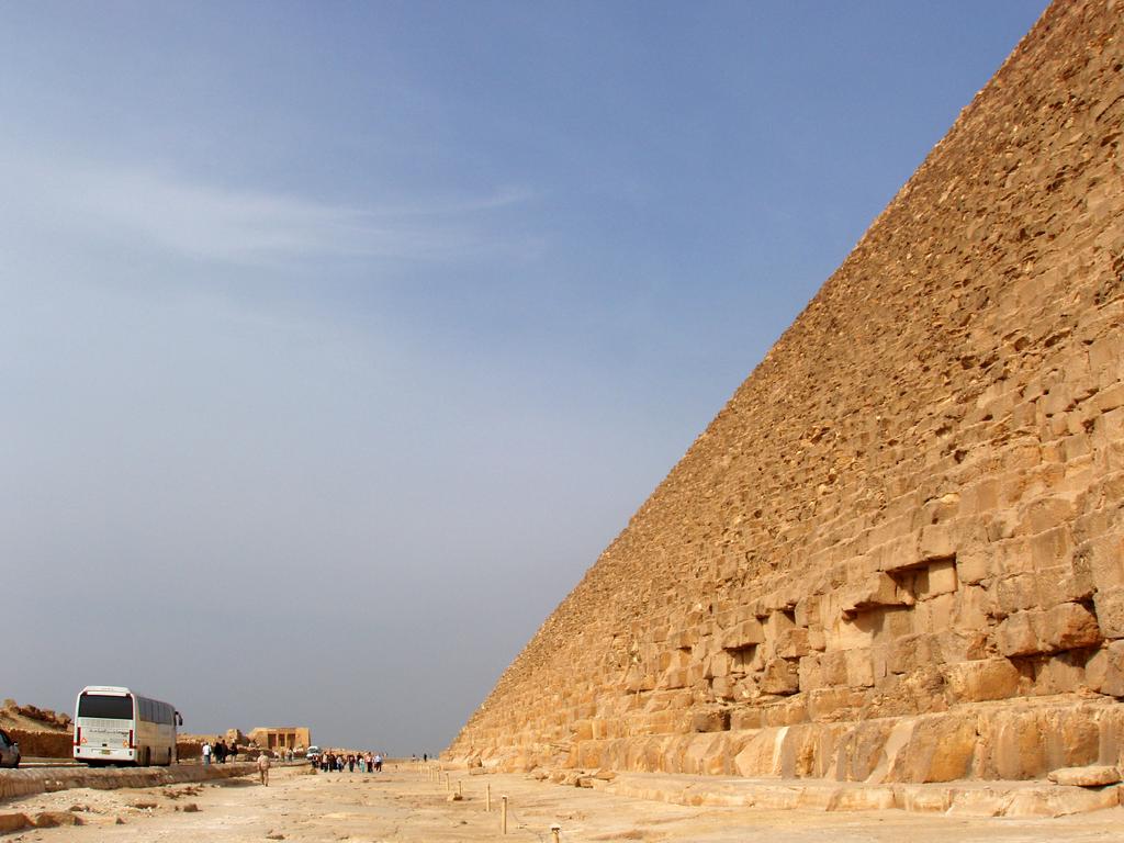 the massive size of the Great Pyramid of Giza in Egypt dwarfs tourists at its base