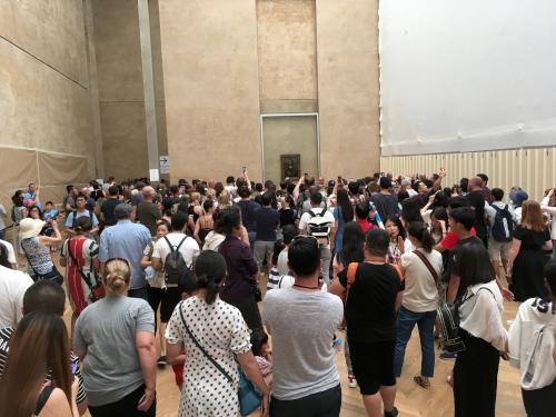 crowd viewing the Mona Lisa at the Louvre in Paris, France