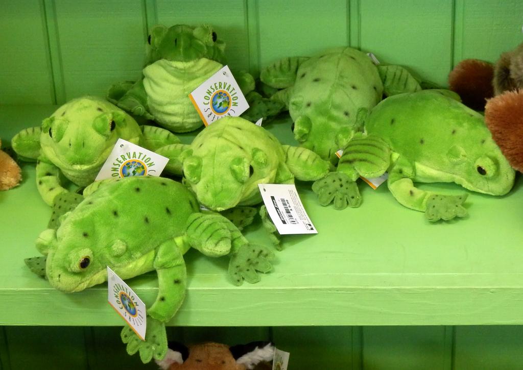 shelf of stuffed frogs