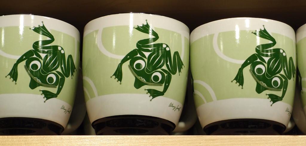 a shelf of froggy mugs in native-american modern-art design