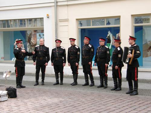 Russian army singing group by a sidewalk cafe at Potsdam in Germany