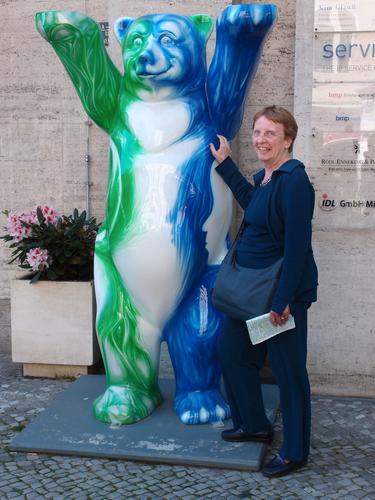 Betty Lou tickles an art bear on a commercial street at Berlin in Germany