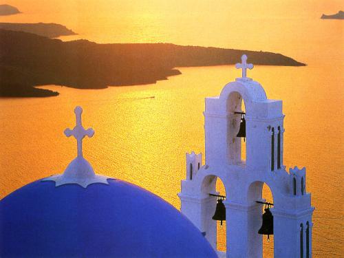 golden-sunset postcard depicting the view from the island of Santorini in Greece