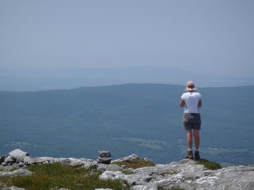 hiker on the summit of Mount Abraham in Vermont