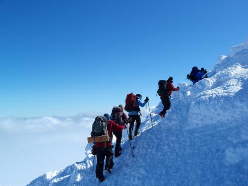 winter hikers ascend the summit of Mount Adams in New Hampshire