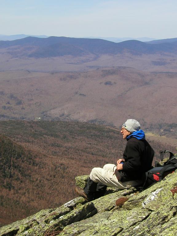 hiker on the edge and view from Durand Ridge in New Hampshire