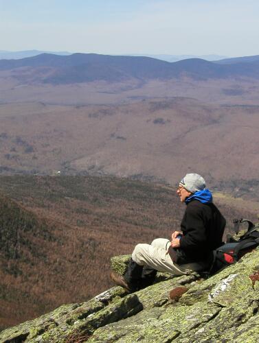 hiker on the edge and view from Durand Ridge in New Hampshire