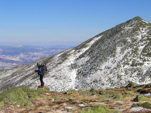 hiker on the Airline Trail in New Hampshire with Mount Madison in the background