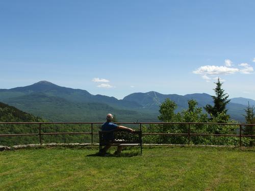 Fred enjoys the amazing front-lawn view from the summit of Mount Agassiz near Franconia in New Hampshire