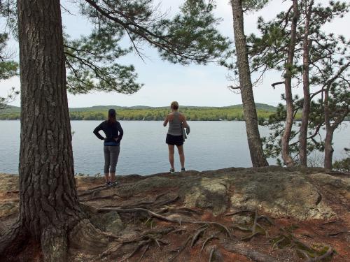 two hikers viewing Winnisquam Lake at Ahern State Park in New Hampshire