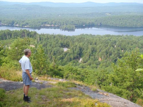 hiker at the summit of Avery Hill in New Hampshire