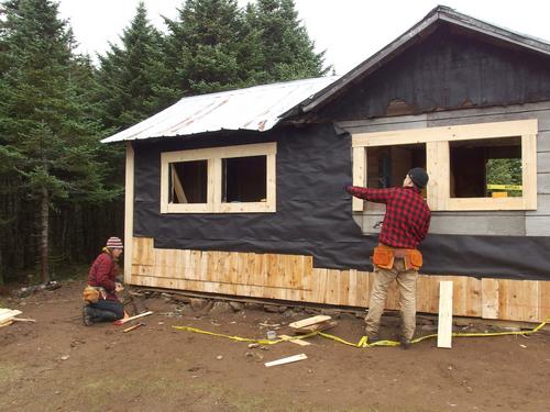 workers restoring the old firewarden's cabin on top of  Bald Mountain in northern Vermont