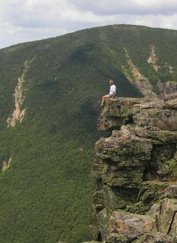 hiker on the edge of Bondcliff Mountain in New Hampshire