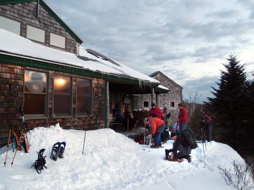 winter hikers at AMC Zealand Falls Hut in the White Mountains of New Hampshire