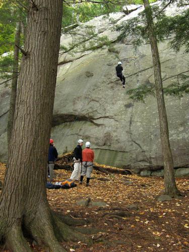 rock climbers at Pawtuckaway Boulder Field in New Hampshire