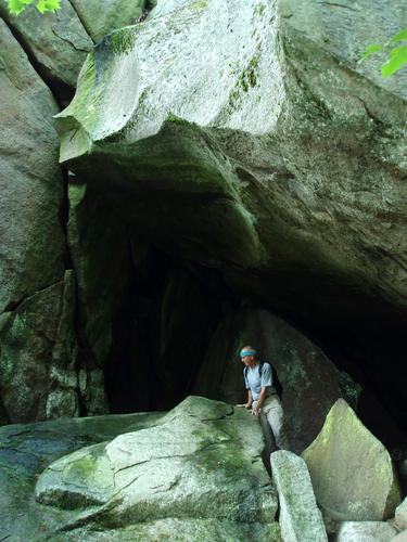 Fred in the entrance to Devil's Den at Pawtuckaway Boulder Field in southern New Hampshire