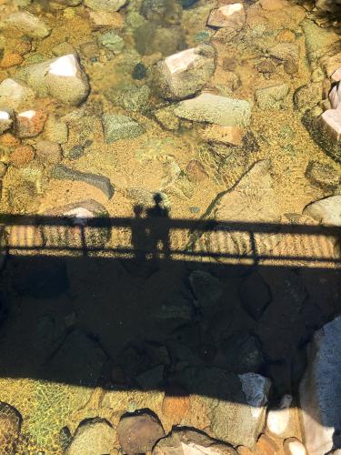 Andee and Fred create an abstract-art shadow from the Rocky Gorge bridge in New Hampshire