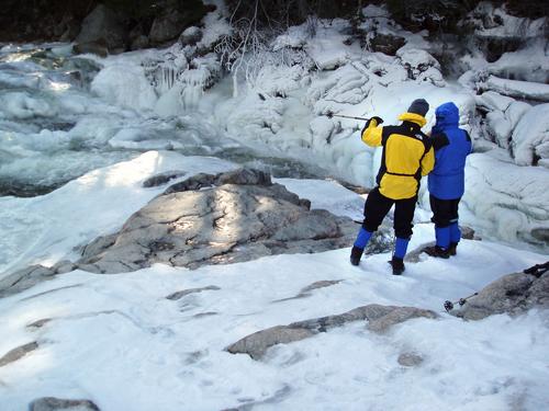 Dave and Dave watch the Swift River in February coat Rocky Gorge in frosty spray in the White Mountains of New Hampshire