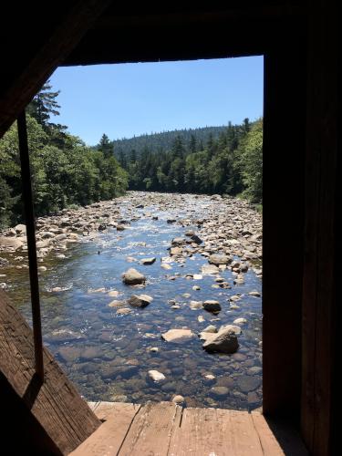 view of Swift River from inside Albany Covered Bridge near Boulder Loop in New Hampshire
