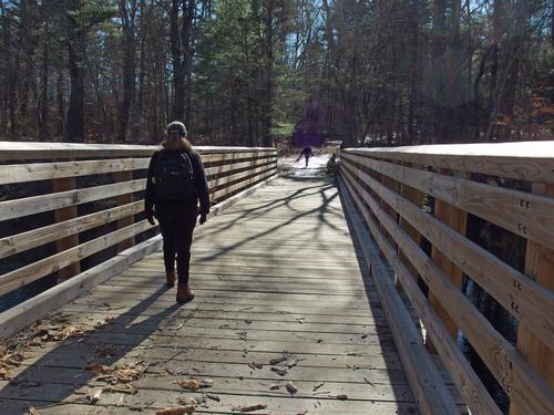 Kate crosses the footbridge into Bradley Palmer State Park in northeastern Massachusetts