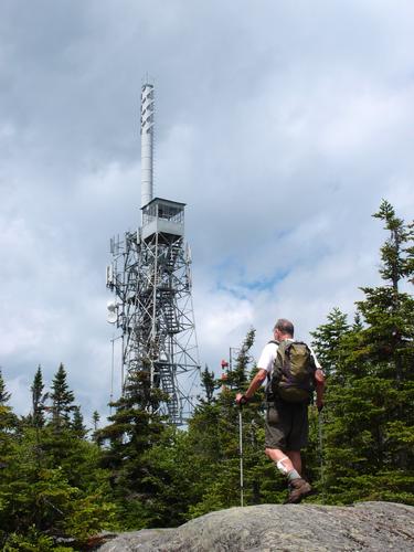 a hiker approaches the towers on top of Burke Mountain in Vermont