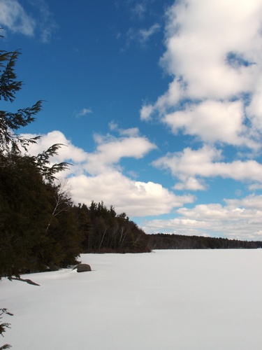 winter view of Nubanusit Lake on the way to Cabot Preserve Peak in New Hampshire