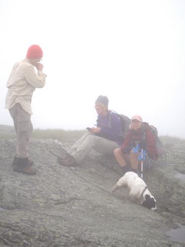 hikers on the foggy summit of Camels Hump in Vermont