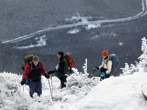 winter hikers near the viewpoint on Cannon Mountain overlooking Franconia Notch in New Hampshire