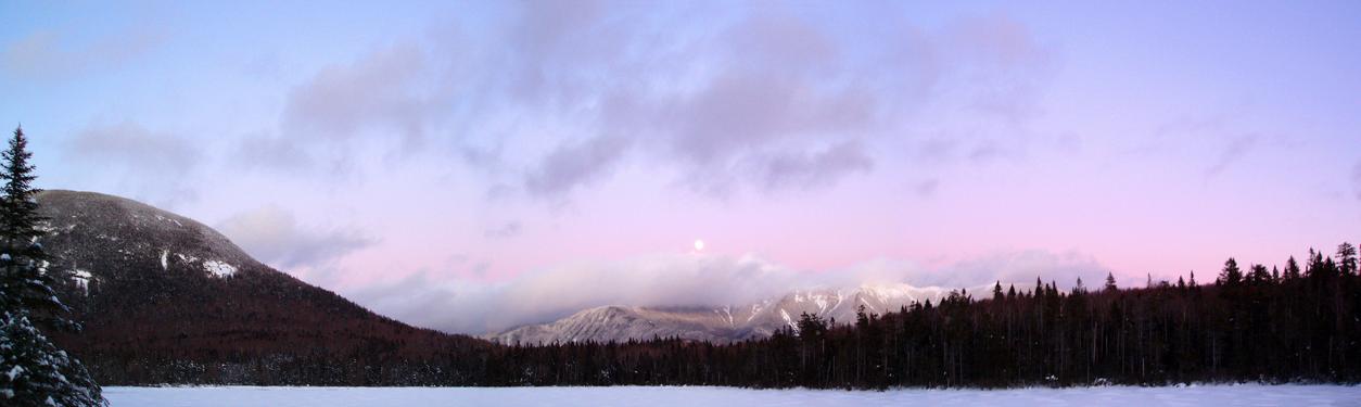 panoramic view of moonrise in January from Lonesome Lake in the White Mountains of New Hampshire