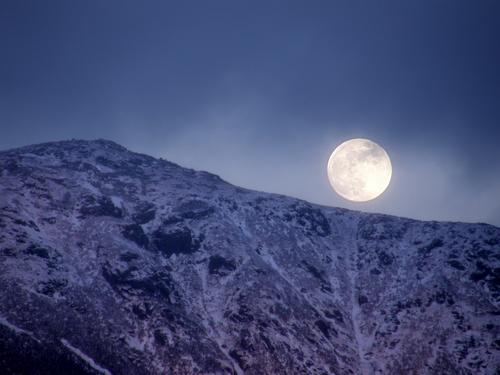 viewed from Lonesome Lake the full moon rises over the shoulder of Mount Lafayette in the White Mountains of New Hampshire