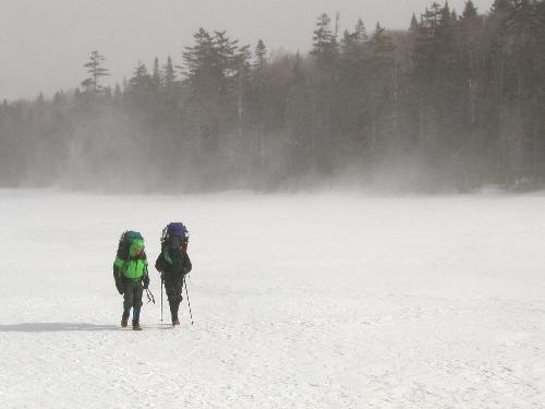 winter hikers crossing Lonesome Lake in New Hampshire