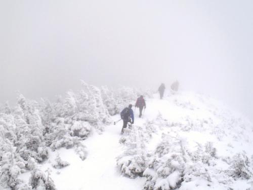winter hikers ascending Signal Ridge to Mount Carrigain in New Hampshire