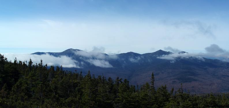 view of the Presidential Range with in-rolling clouds from Carter Ridge in the White Mountains of New Hampshire