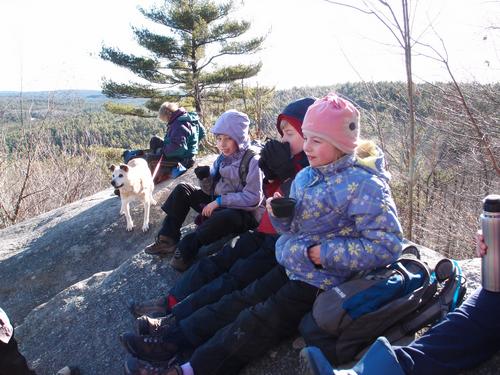 winter hikers enjoying cocoa on Catamount Hill in New Hampshire