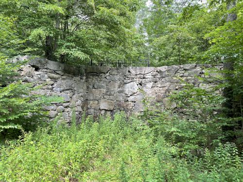 historic stone wall in August for the Springdale Mill beside Mass Central Rail Trail at Holden in eastern Massachusetts