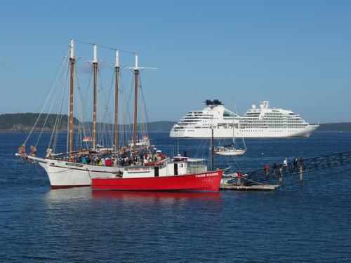a trio of tourist boats -- for fishing, sailing and cruising -- at Bar Harbor near Acadia National Park and Champlain Mountain in Maine