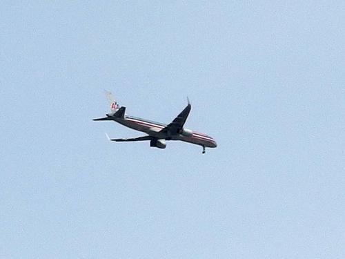 a plane flying over Chickatawbut Hill in Blue Hills Reservation just south of Boston, Massachusetts